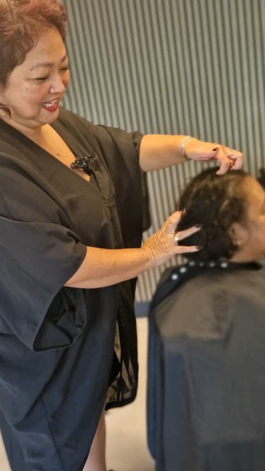 Melissa styling a client’s hair