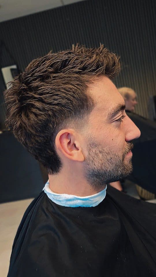 Textured top with a fade and beard, side view