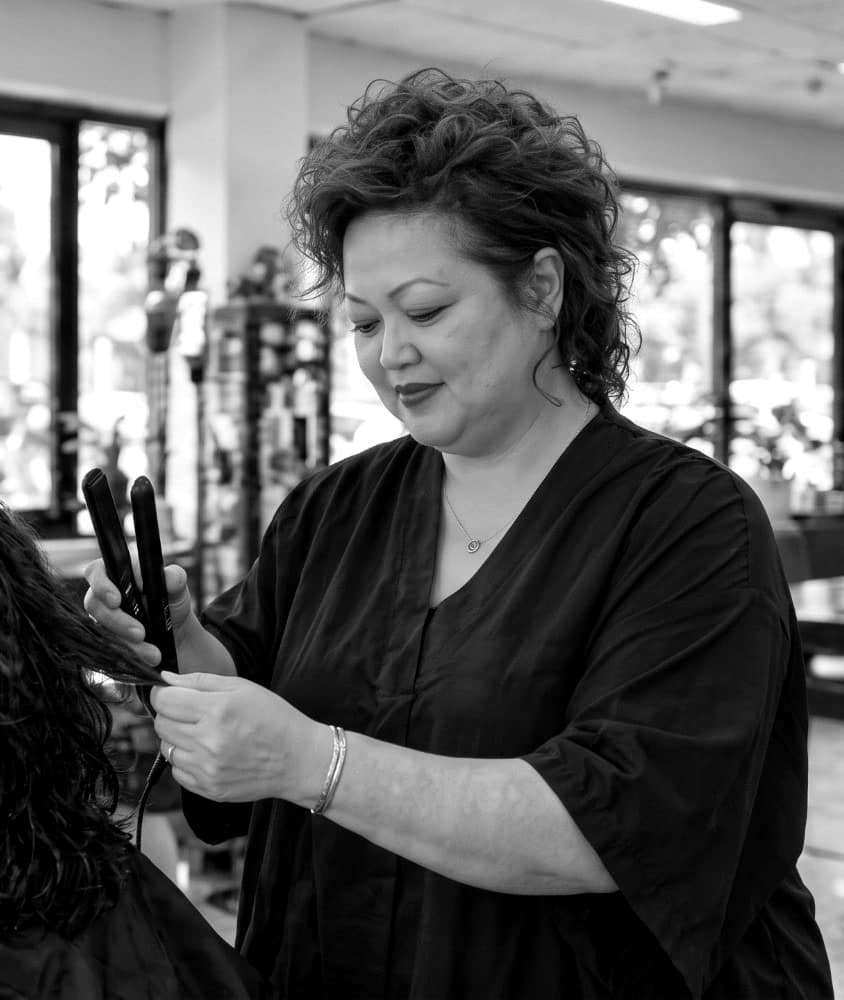 Melissa at work with a flat iron